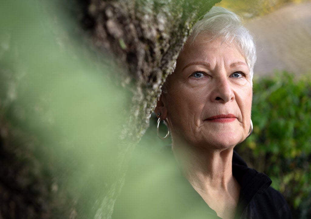 A close up photo of Lori Phillips near a tree