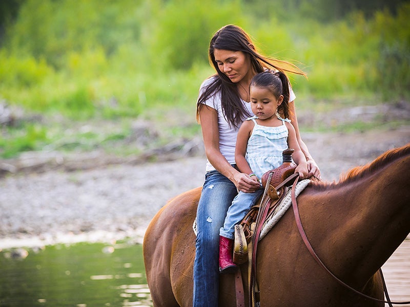 Kendall Edmo, with her two year old daughter, in the Badger-Two Medicine.