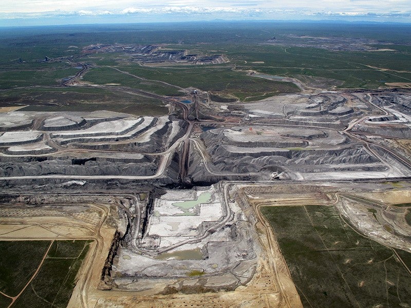 north-antelope-mine-Ecoflight-800 An aerial view of North Antelope Mine in Wyoming's Powder River Basin shows a deep, expansive tiered pit. The pit is so large, machinery inside the pit is dwarfed by the walls.